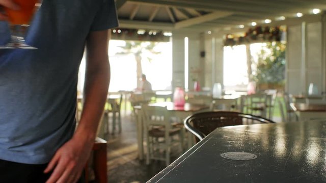 Close up Cash payment for alcohol, the visitor gives the money to the bartender, barkeep sells drink