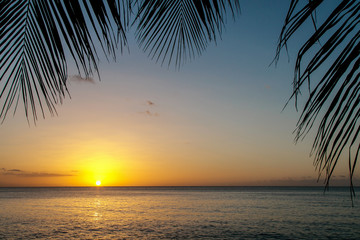Naklejka na ściany i meble Sunset over ocean in Grenada.