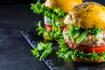 Colored yellow burgers. Chicken burgers hamburgers with turmeric bread