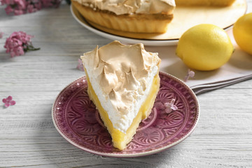 Piece of delicious lemon meringue pie on plate