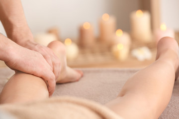 Obraz na płótnie Canvas Young woman having legs massage in spa salon, closeup