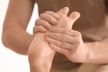 Young woman having foot massage in spa salon, closeup