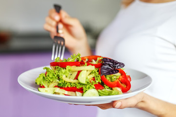 A delicious salad with vegetables and herbs. Gourmet dish. The concept is healthy food, diet, vegetarianism, weight loss.