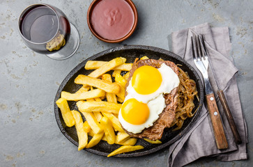 Peruvian Latin American food. Lomo a lo pobre. Beef tenderloin whit fried potatoes french fries and...