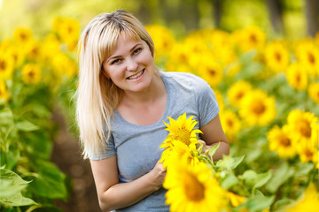 young beautiful woman in the field of sunflowers