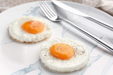 Homemade sunny side up fried eggs on plate