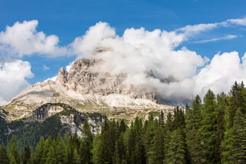 Wallpaper with mountain wrapped in clouds
