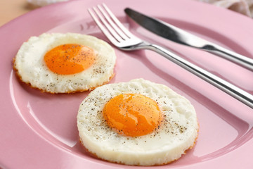 Homemade sunny side up fried eggs on plate