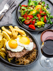 Peruvian Latin American food. Lomo a lo pobre. Beef tenderloin whit fried potatoes french fries and eggs