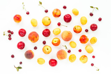 Colorful fruits assorted. Healthy fresh fruit background with plum, nectarine, peach, apricot, cherry, cherries on white background. Flat lay, top view