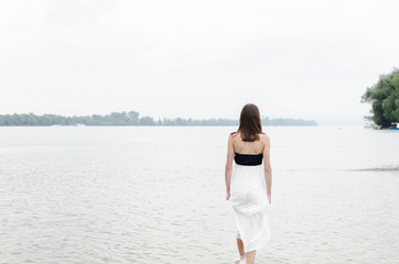 sadness woman walking on the river