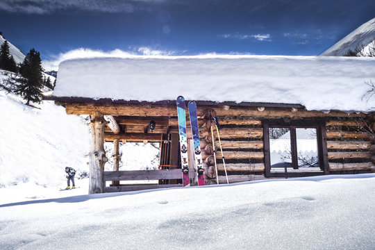 Verschneite Hütte mit Ski in den Alpen
