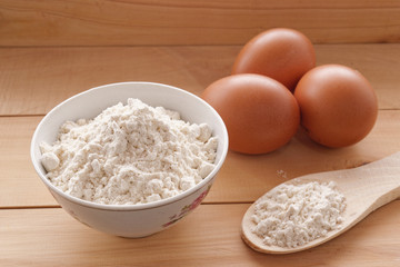 Cup with flour and eggs