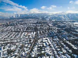 Aerial drone shot of Santiago de Chile at winter. Snowy cityscape of the city