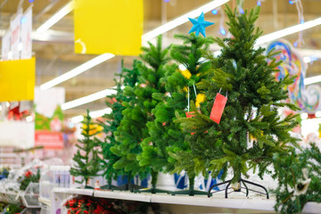 Artificial christmas trees ion shelf n different sizes in supermarket