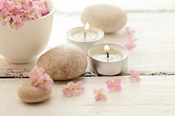 Fototapeta na wymiar candles,flowers and pebbles