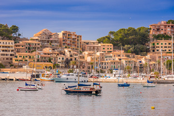 Fototapeta na wymiar Puerto de Soller, Port of Mallorca island in balearic islands, Spain. Beautiful beach and bay with boats in clear blue water of summer day.