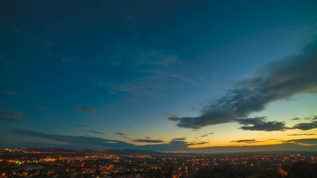 The clouds stream over the city. night to day transition. time lapse