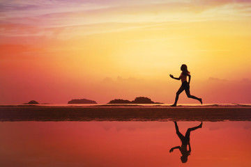 sport background, silhouette of woman running on the beach