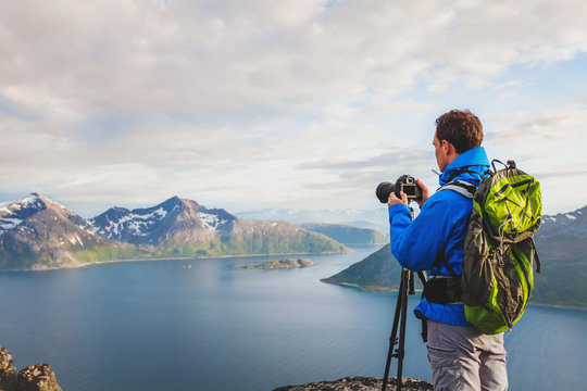 professional landscape and nature photographer with tripod outdoors, travel to Norway
