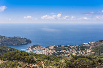 Fototapeta na wymiar Puerto de Soller, Port of Mallorca island in balearic islands, Spain. Beautiful beach and bay with boats in clear blue water of summer day.
