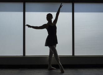 Fototapeta na wymiar Ballet dancer Silhouette in a Window frame