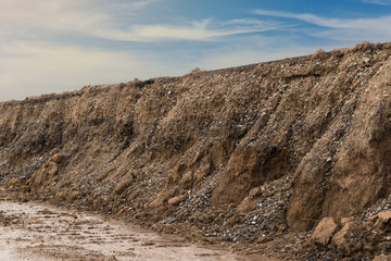 Soil eroded under dirt road.