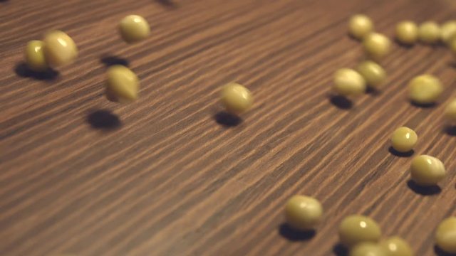 Canned green peas on a brown wooden background. 2 Shots. Slow motion. Vertical pan. Close-up.