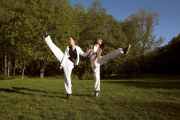 two girl jumping in park