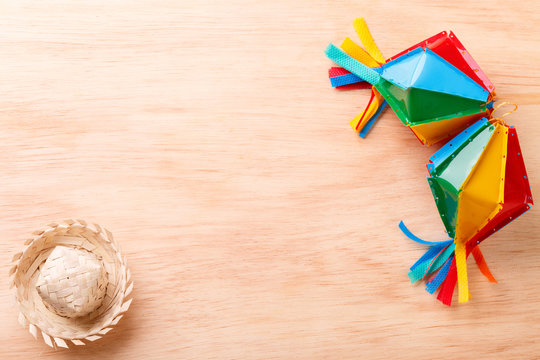 Wooden background with wicker hat for brazilian festivel Festa Junina