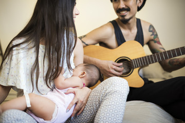 Fototapeta premium Father and mother are taking care of their child.