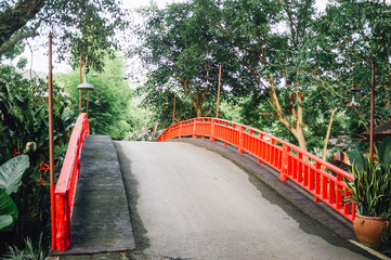 The bridge with red Rail bridge in garden.