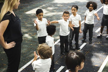 Group of diverse kindergarten students standing together