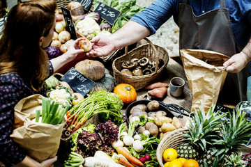 People buying fresh organic vegetable at market - obrazy, fototapety, plakaty