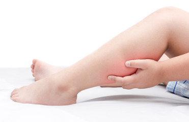 Leg pain or calf muscle in a boy on bed isolated
