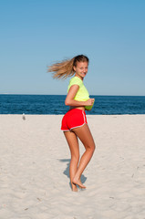 Fitness woman doing exercise on the beach.