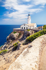 Fototapeta na wymiar Capdepera Lighthouse. Mallorca island, Spain. This beautiful lighthouse is located at the easternmost point of Mallorca not far away from Cala Ratjada.