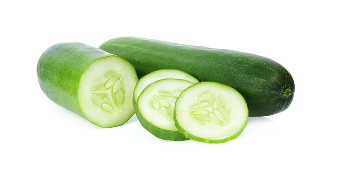 Fresh whole cucumber and chopped cucumber isolated on white background