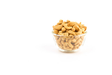 cashew nuts in glass bowl on white background.