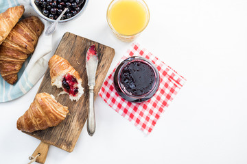 Fresh croissant with blueberry marmelade