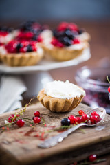 Making black and red currant tart with cottage cheese