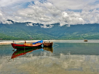 Boats clouds and mountain