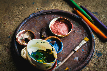 Paint brushes and color palettes are already in use.