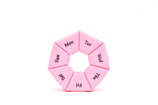 Heptagonal dispenser for a week of pills isolated against a white background