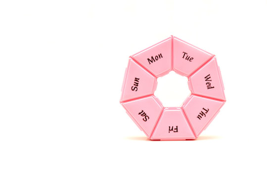 Heptagonal dispenser for a week of pills isolated against a white background
