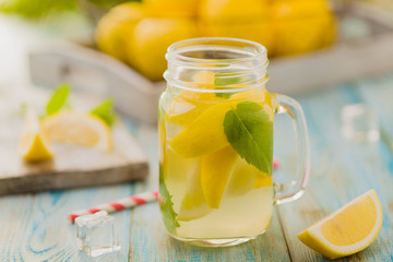 lemonade with mint on rocks served in jar with a straw