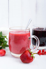 Berry smoothie in of glass cups, fresh berries on white wooden background. Proper nutrition. Healthy breakfast. Dietary menu.