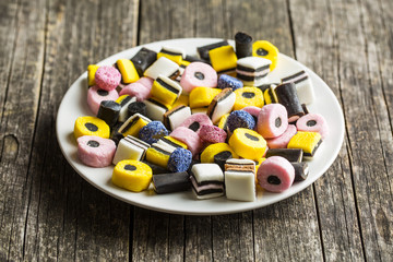 Mixed liquorice candies on plate.