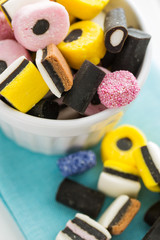 Mixed liquorice candies in bowl.