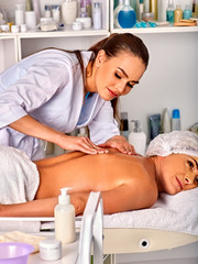 Obraz na płótnie Canvas Massage room for therapy deals. Woman therapist making manual therapy back. Hands of masseuse treatment of spinal injuries 40 old client in spa salon. Woman rests in an elite spa salon.